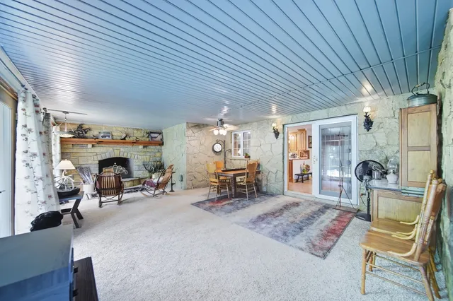 a spacious bedroom with a bed and wooden floor