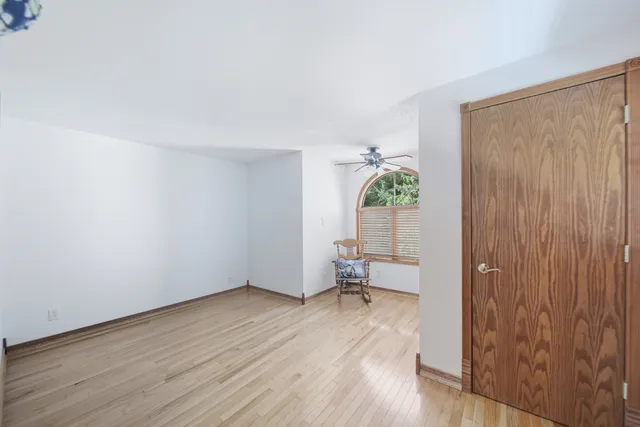 a spacious bedroom with a bed and a table in it