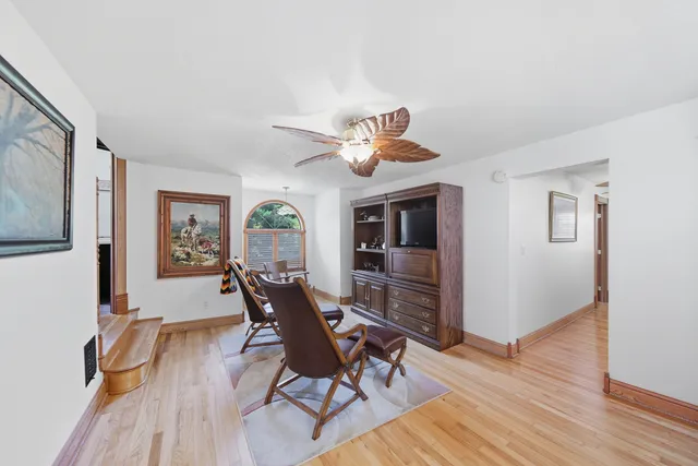 a living room with furniture a floor to ceiling window and a flat screen tv