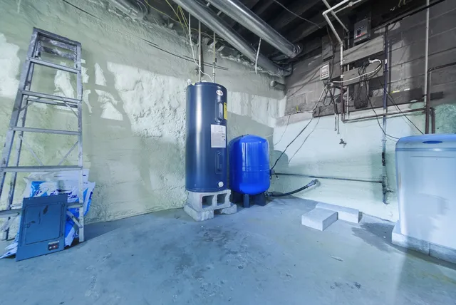 a view of a white house with a big yard plants and large trees