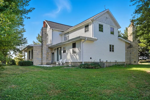 a front view of house with yard and green space