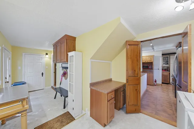 a kitchen with lots of counter top space and two windows
