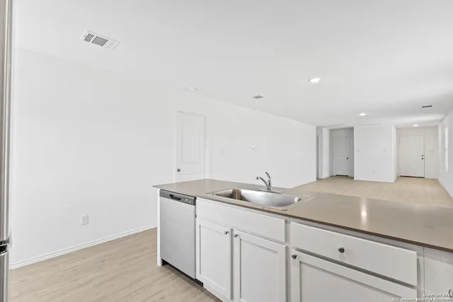 a kitchen with a sink and cabinets