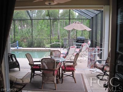 6119 Manchester Place Naples, FL 34110 - Photo 4 of 10 a dining room with furniture and chandelier kitchen view