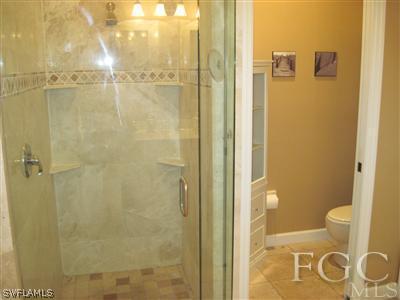 6119 Manchester Place Naples, FL 34110 - Photo 9 of 10 a bathroom with a granite countertop shower