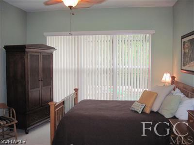 6119 Manchester Place Naples, FL 34110 - Photo 10 of 10 a bedroom with a bed and window