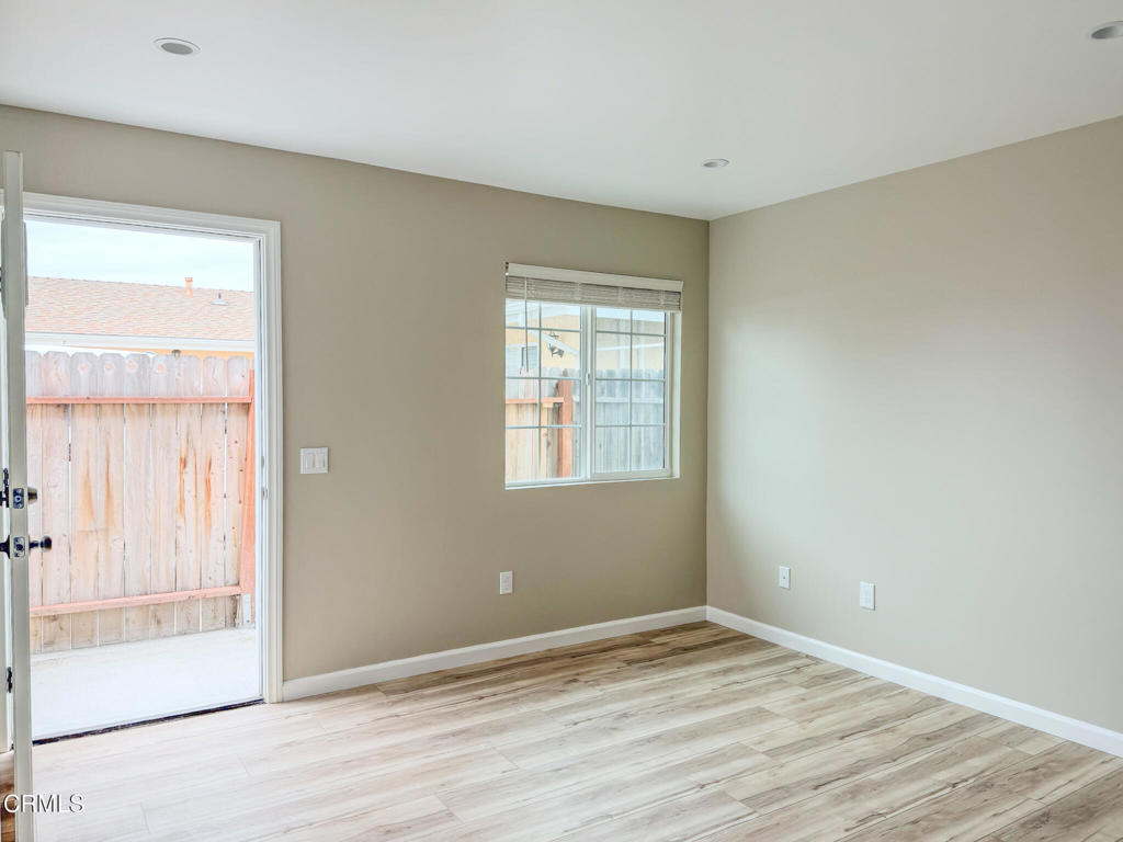 1301 Kingswood Way, Unit 2 Oxnard, CA 93030 - Photo 2 of 18 a view of an empty room with wooden floor and a window