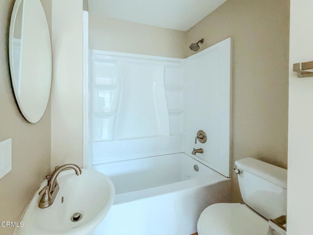 1301 Kingswood Way, Unit 2 Oxnard, CA 93030 - Photo 5 of 18 a bathroom with a sink a mirror toilet and bathtub