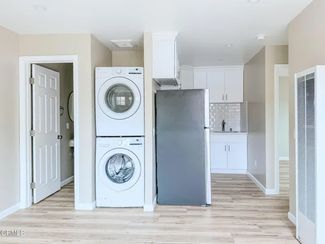 a utility room with sink dryer and washer