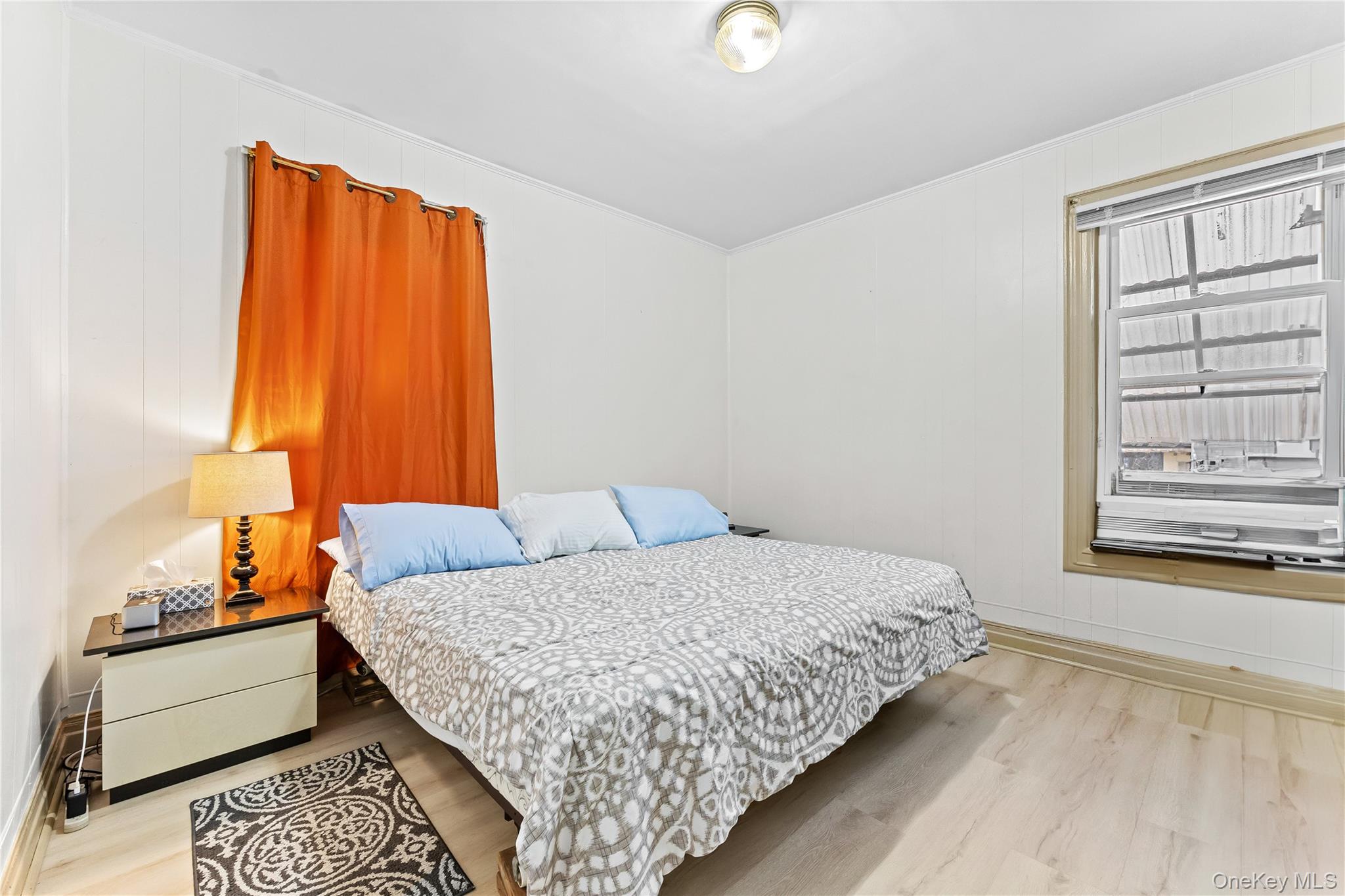 91-49 86th Street Queens, NY 11421 - Photo 12 of 42 a bedroom with a bed and a window