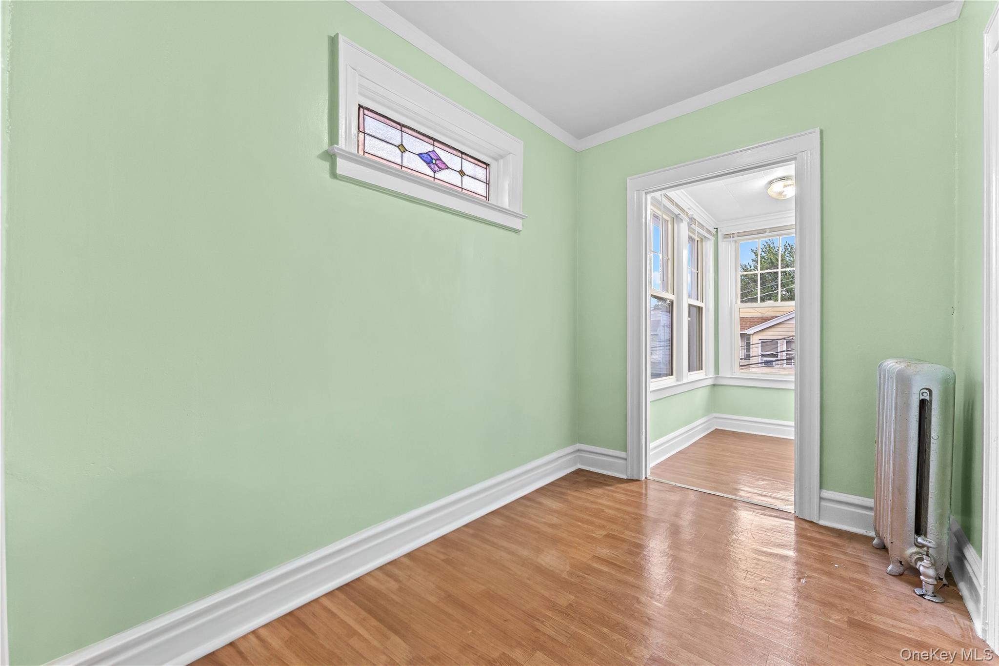 91-49 86th Street Queens, NY 11421 - Photo 20 of 42 an empty room with wooden floor and windows