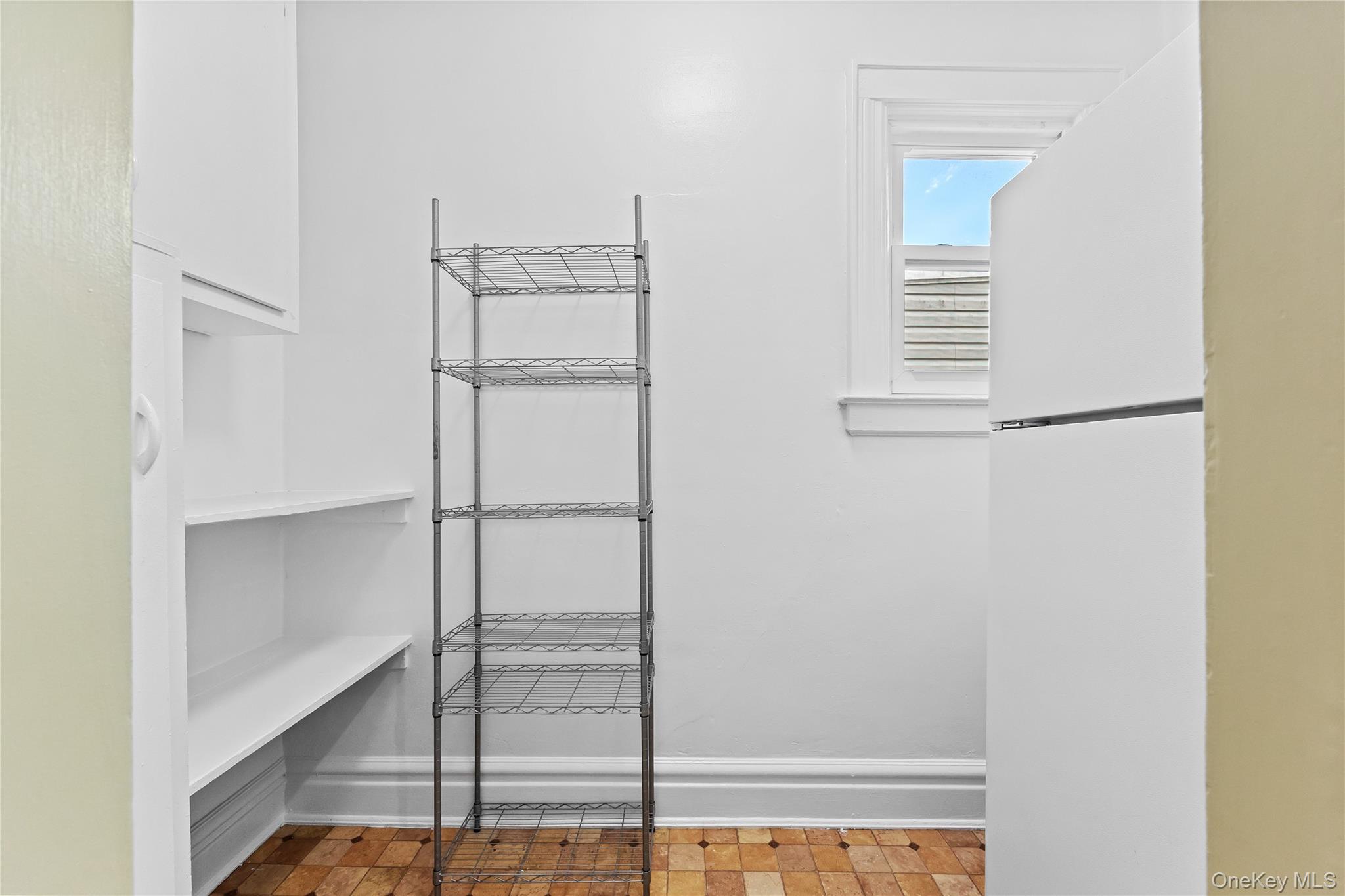 91-49 86th Street Queens, NY 11421 - Photo 26 of 42 a view of walk in closet with empty racks