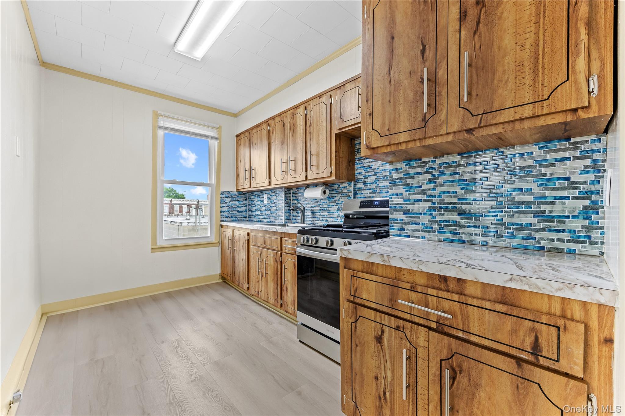 91-49 86th Street Queens, NY 11421 - Photo 27 of 42 a kitchen with granite countertop cabinets stainless steel appliances and a counter space