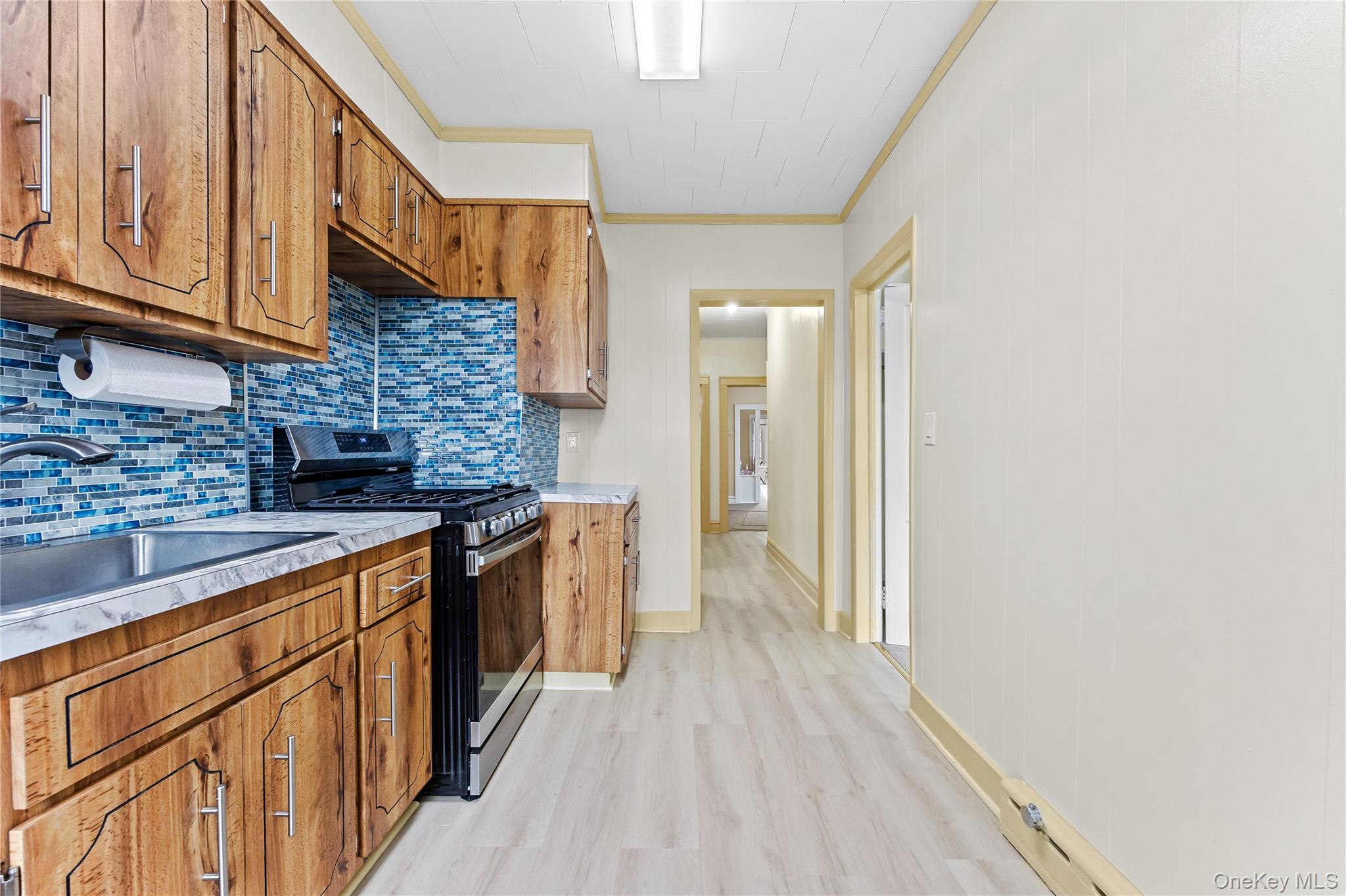91-49 86th Street Queens, NY 11421 - Photo 28 of 42 a kitchen with stainless steel appliances granite countertop a stove and a sink