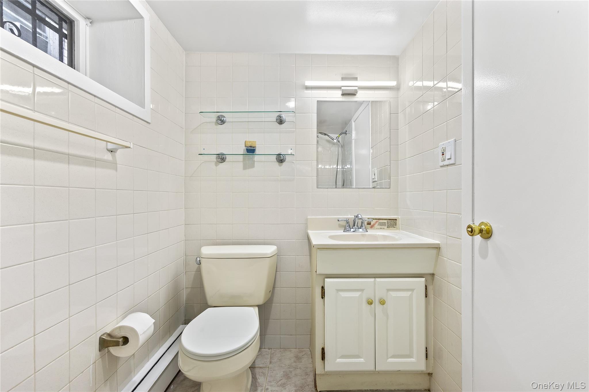 91-49 86th Street Queens, NY 11421 - Photo 35 of 42 a bathroom with a granite countertop toilet a sink and mirror