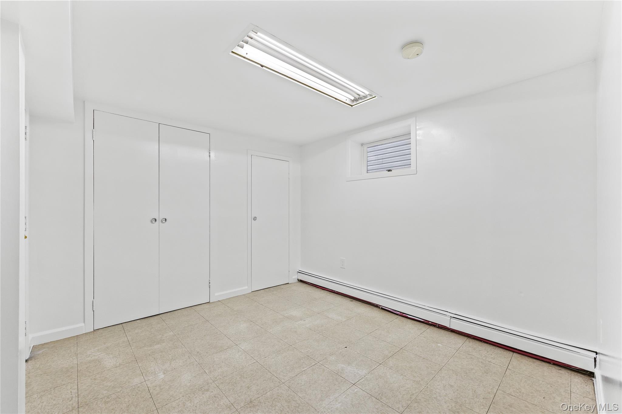 91-49 86th Street Queens, NY 11421 - Photo 36 of 42 wooden floor in an empty room