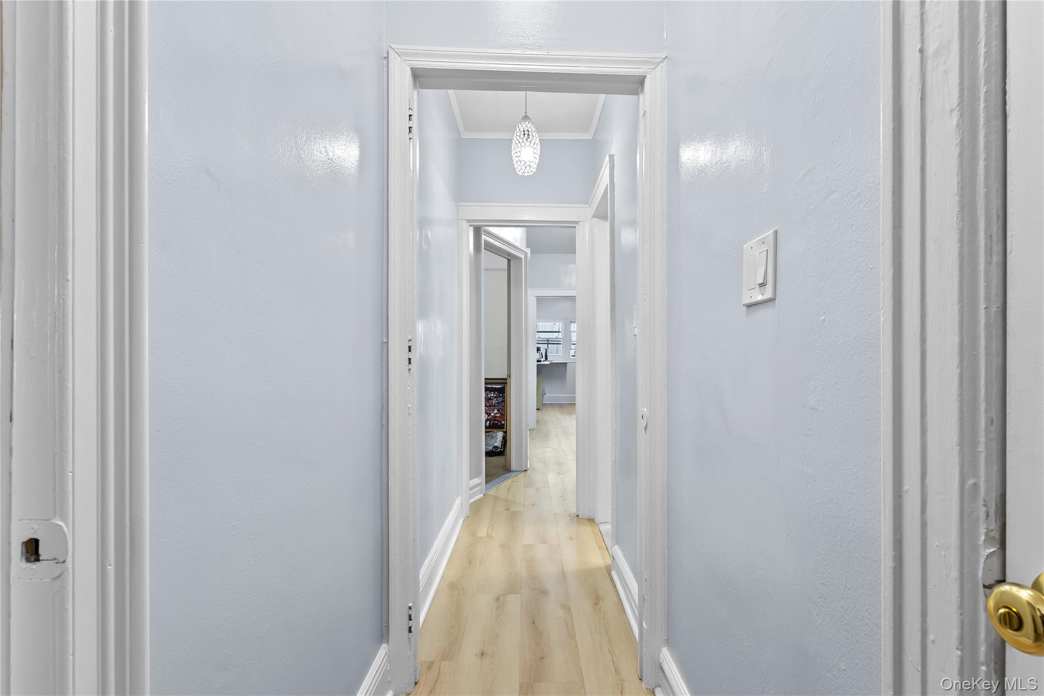 91-49 86th Street Queens, NY 11421 - Photo 4 of 42 a view of a hallway with wooden floor and a bathroom