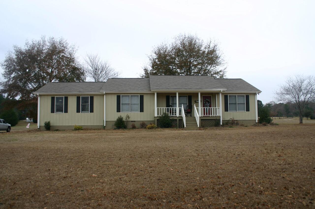 1340 Price Mill Road Madison, GA 30650 - Photo 1 of 1 a front view of a house with a garden