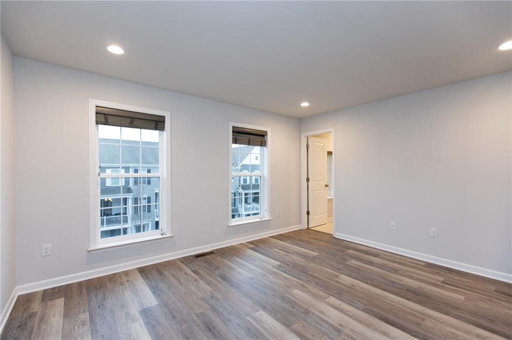 107 Gress Road Cranberry Township, PA 16066 - Photo 12 of 23 The primary bedroom serves as a peaceful and spacious retreat, highlighted by abundant natural light from large windows and a clean, neutral color palette that enhances the room’s airy feel.