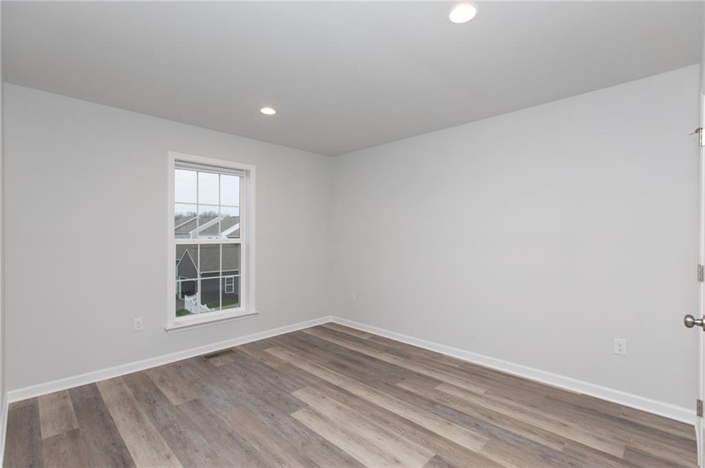 107 Gress Road Cranberry Township, PA 16066 - Photo 14 of 23 his bedroom offers a bright, airy retreat with a clean, modern feel that’s both comfortable and versatile. Recessed ceiling lights add soft, even illumination, making the space feel warm and welcoming at any time of day.