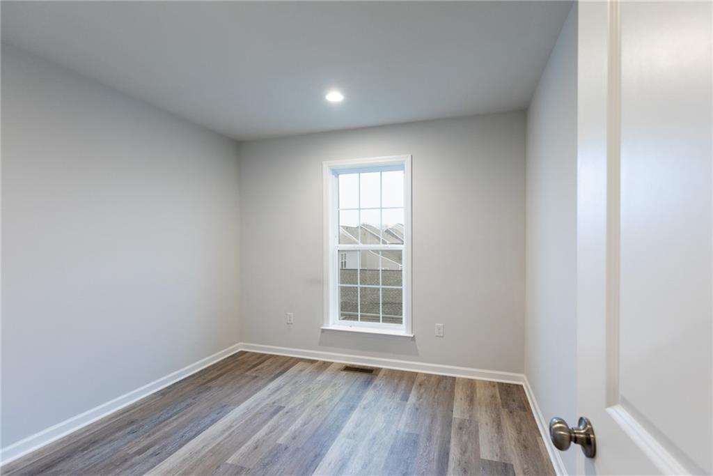 107 Gress Road Cranberry Township, PA 16066 - Photo 15 of 23 his bedroom offers a bright, airy retreat with a clean, modern feel that’s both comfortable and versatile. Recessed ceiling lights add soft, even illumination, making the space feel warm and welcoming at any time of day.