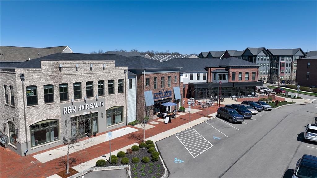 107 Gress Road Cranberry Township, PA 16066 - Photo 17 of 23 In the heart of the community, a collection of stylish retail storefronts and local amenities adds energy and convenience, placing dining, coffee shops, and everyday services just steps from home. Visible gathering spaces and pedestrian-friendly paths highlight a lifestyle built around connection and accessibility.
