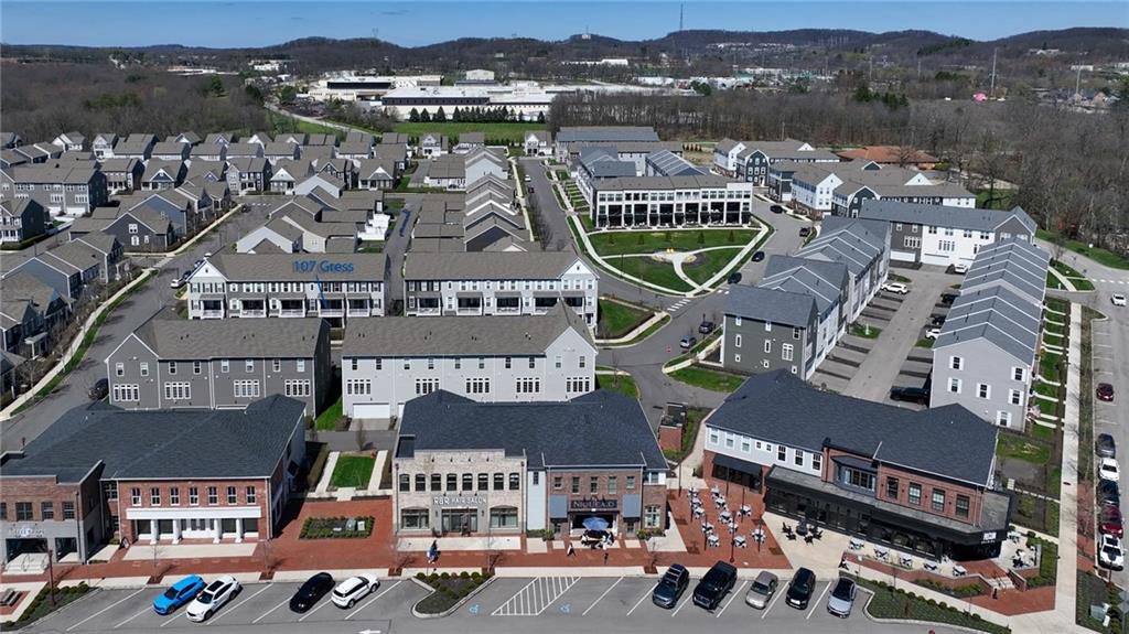 107 Gress Road Cranberry Township, PA 16066 - Photo 18 of 23 This striking aerial view showcases the best of community-centered living, where charming townhomes and vibrant neighborhood shops come together seamlessly.