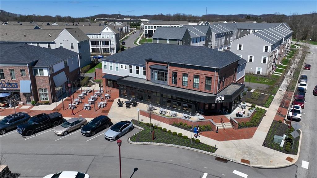 107 Gress Road Cranberry Township, PA 16066 - Photo 19 of 23 In the heart of the community, a collection of stylish retail storefronts and local amenities adds energy and convenience, placing dining, coffee shops, and everyday services just steps from home. Visible gathering spaces and pedestrian-friendly paths highlight a lifestyle built around connection and accessibility.