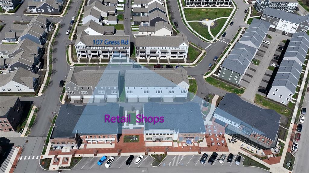 107 Gress Road Cranberry Township, PA 16066 - Photo 20 of 23 This striking aerial view showcases the best of community-centered living, where charming townhomes and vibrant neighborhood shops come together seamlessly.