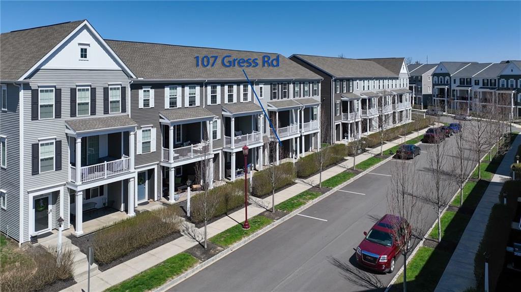 107 Gress Road Cranberry Township, PA 16066 - Photo 22 of 23 Rows of beautifully designed townhomes line quiet, walkable streets, creating a cohesive and welcoming residential setting with sidewalks, green spaces, and thoughtful landscaping throughout.