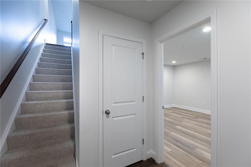 107 Gress Road Cranberry Township, PA 16066 - Photo 4 of 23 The entry level welcomes you with a clean, polished look and a thoughtful layout that immediately feels both functional and inviting. Plush carpeting on the staircase leads upstairs, creating a soft contrast to the crisp white walls and dark handrail detail.