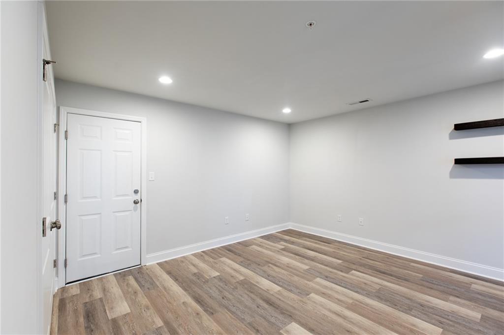 107 Gress Road Cranberry Township, PA 16066 - Photo 6 of 23 The lower-level family room is a bright, welcoming space that offers exceptional versatility and comfort. Large windows bring in natural light, creating an open and inviting atmosphere rarely found on a lower level. Recessed lighting enhances the room’s warmth.