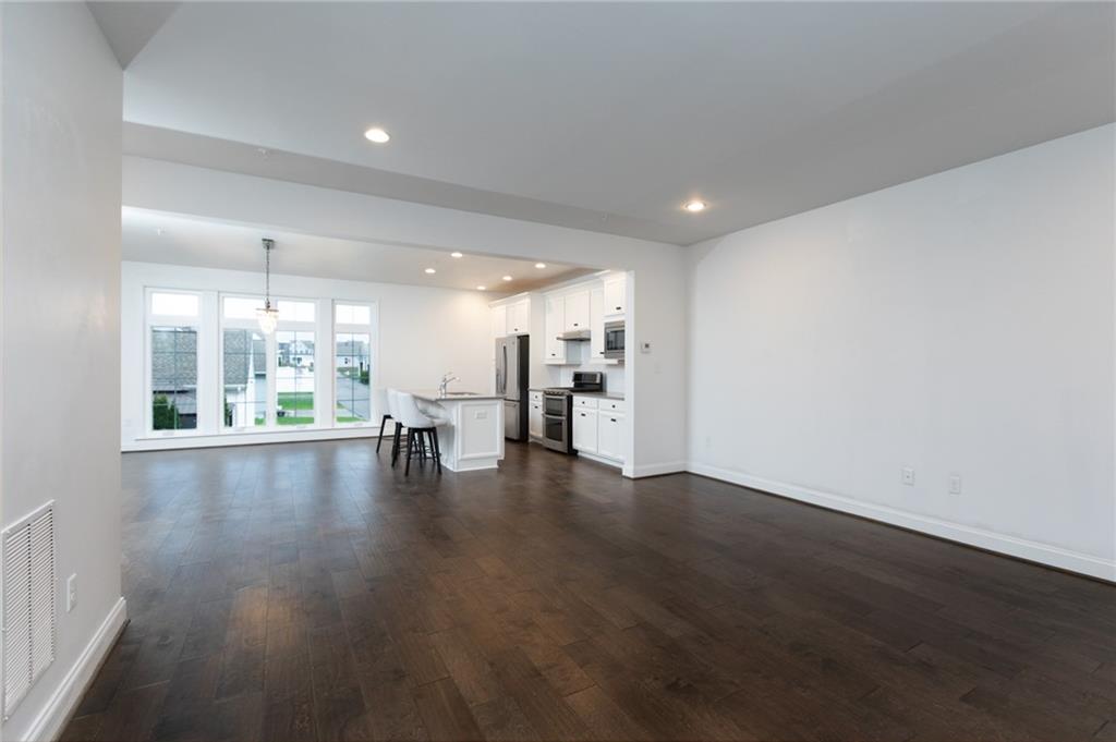 107 Gress Road Cranberry Township, PA 16066 - Photo 8 of 23 The open floor plan seamlessly connects the living room and kitchen, creating a bright, expansive space that is ideal for both everyday living and entertaining.