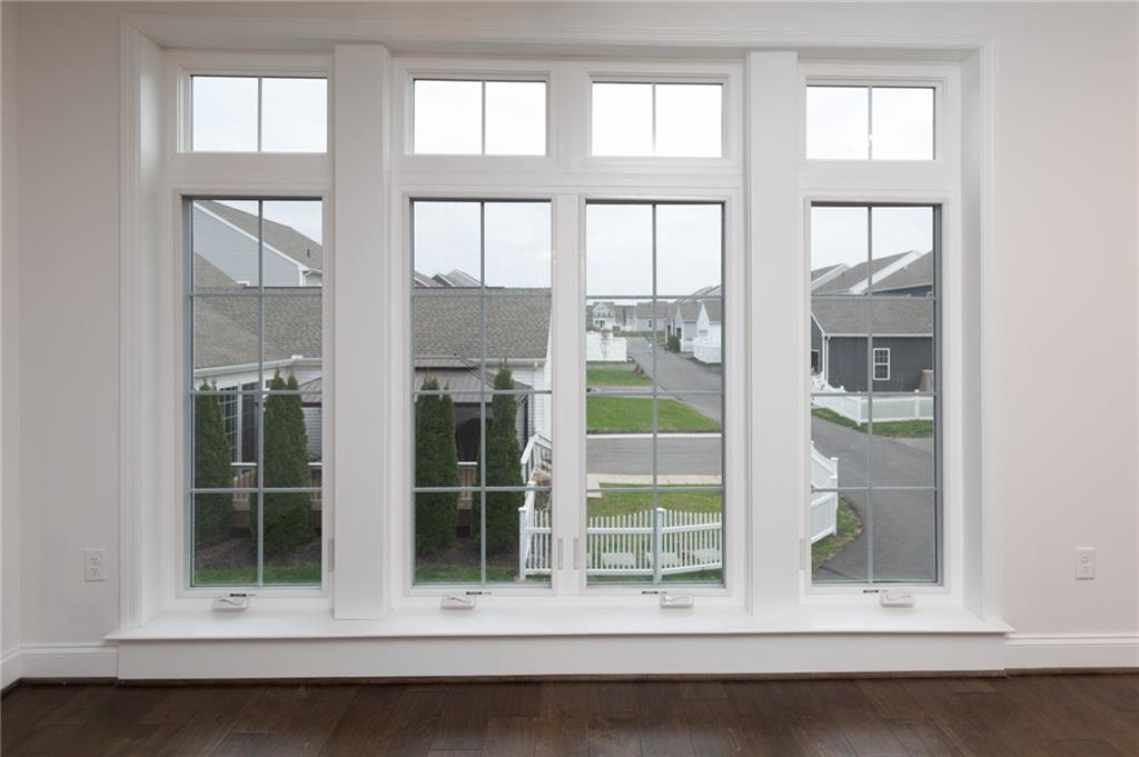 107 Gress Road Cranberry Township, PA 16066 - Photo 9 of 23 The dining area is beautifully enhanced by a wall of large, oversized windows that flood the space with natural light and create an airy, open atmosphere. These expansive windows frame charming neighborhood views while making the room feel bright and welcoming throughout the day.