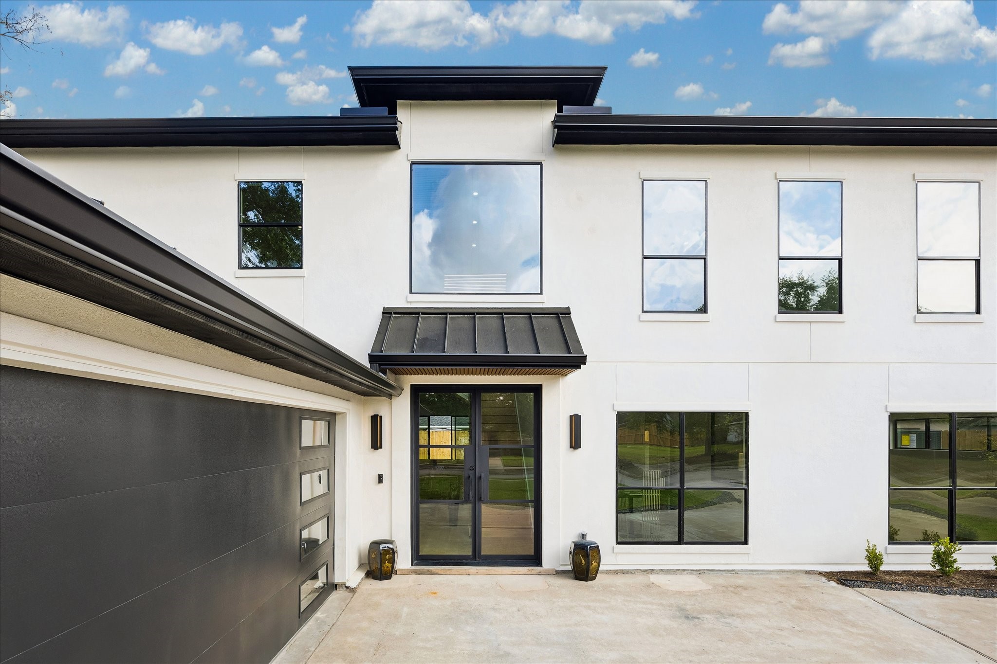 5430 Rutherglenn Drive Houston, TX 77096 - Photo 27 of 31 Close up and luxurious.... even a contemporary garage door, and a stylish entrance with a glass front door. The spacious driveway and minimalist landscaping enhance its curb appeal.