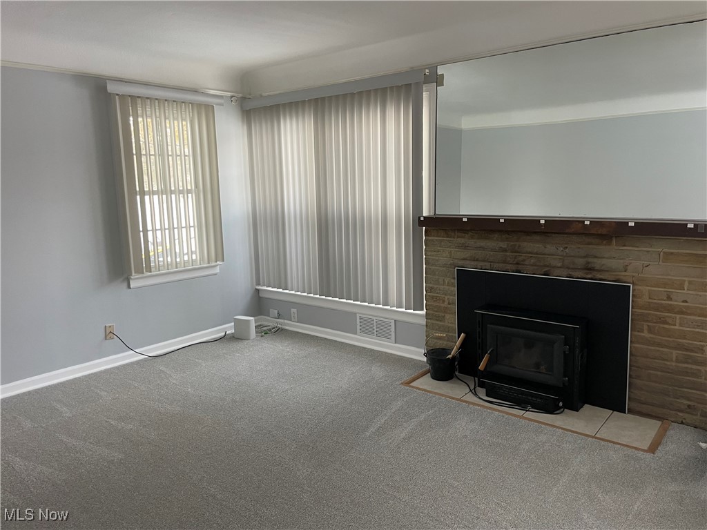 8428 Ridge Road North Royalton, OH 44133 - Photo 7 of 29 Unfurnished living room with carpet floors and a fireplace with flush hearth