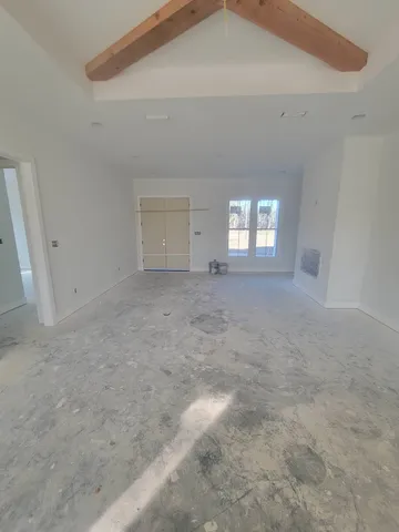 a view of a livingroom with wooden floor and windows