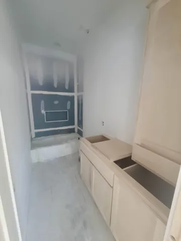 a view of an empty room and a window