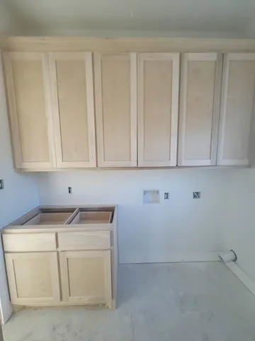 a view of an empty room with furniture and staircase