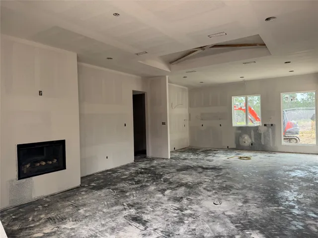 a view of an empty room with a fireplace