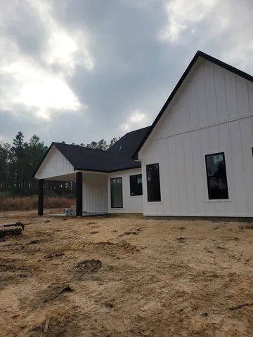 a front view of house with yard and trees