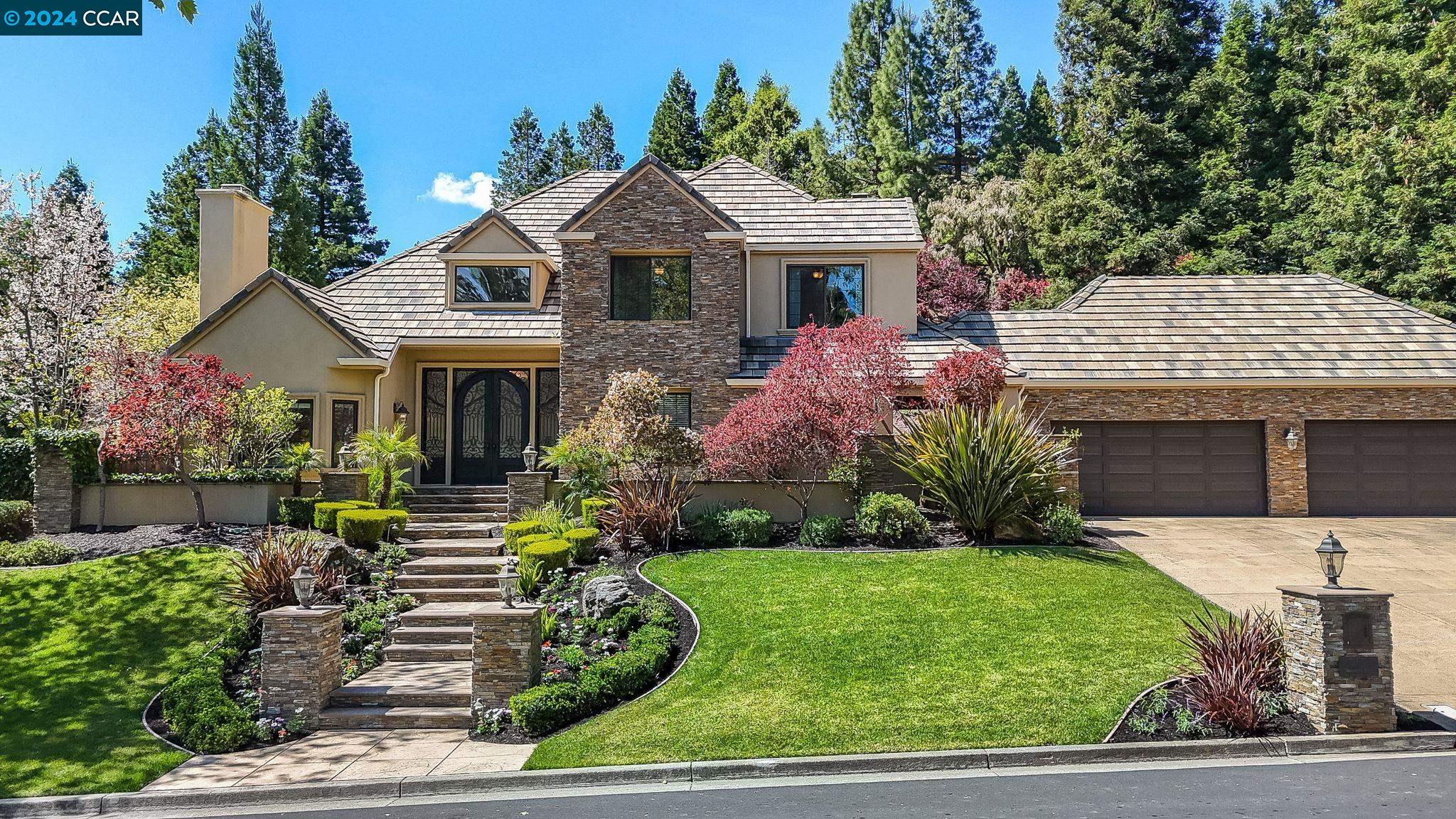 a front view of a house with a garden