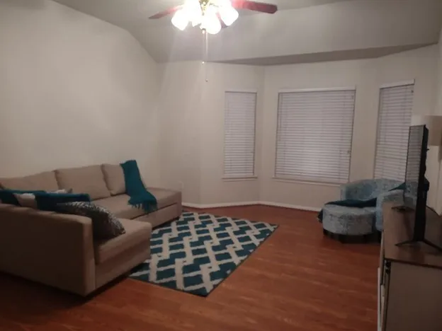 a bedroom with bed and a chandelier
