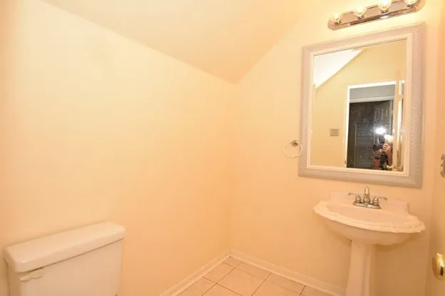 a bathroom with a sink a toilet and mirror