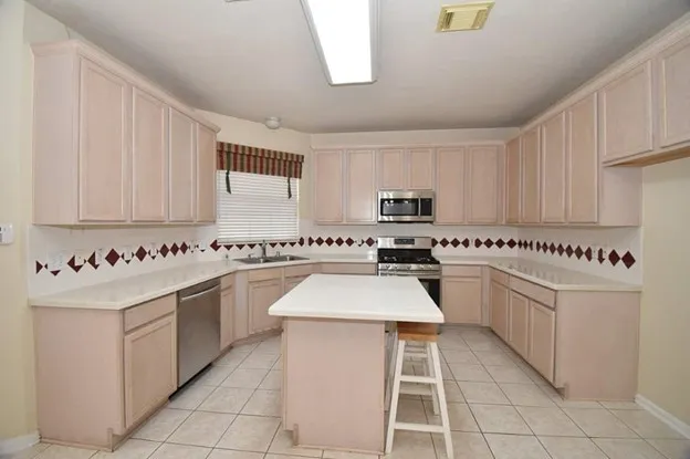 a kitchen with stainless steel appliances granite countertop a sink and cabinets