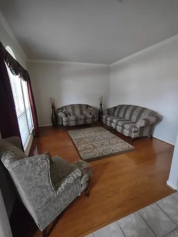 a living room with furniture and a rug