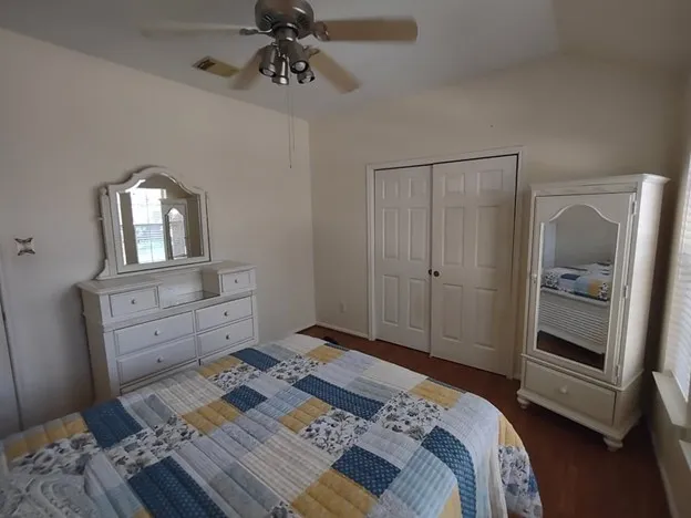 a bedroom with a bed and wooden floor