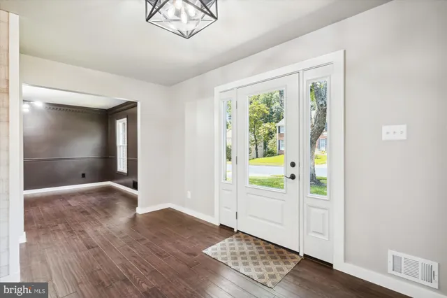 a view of a room with wooden floors and stairs