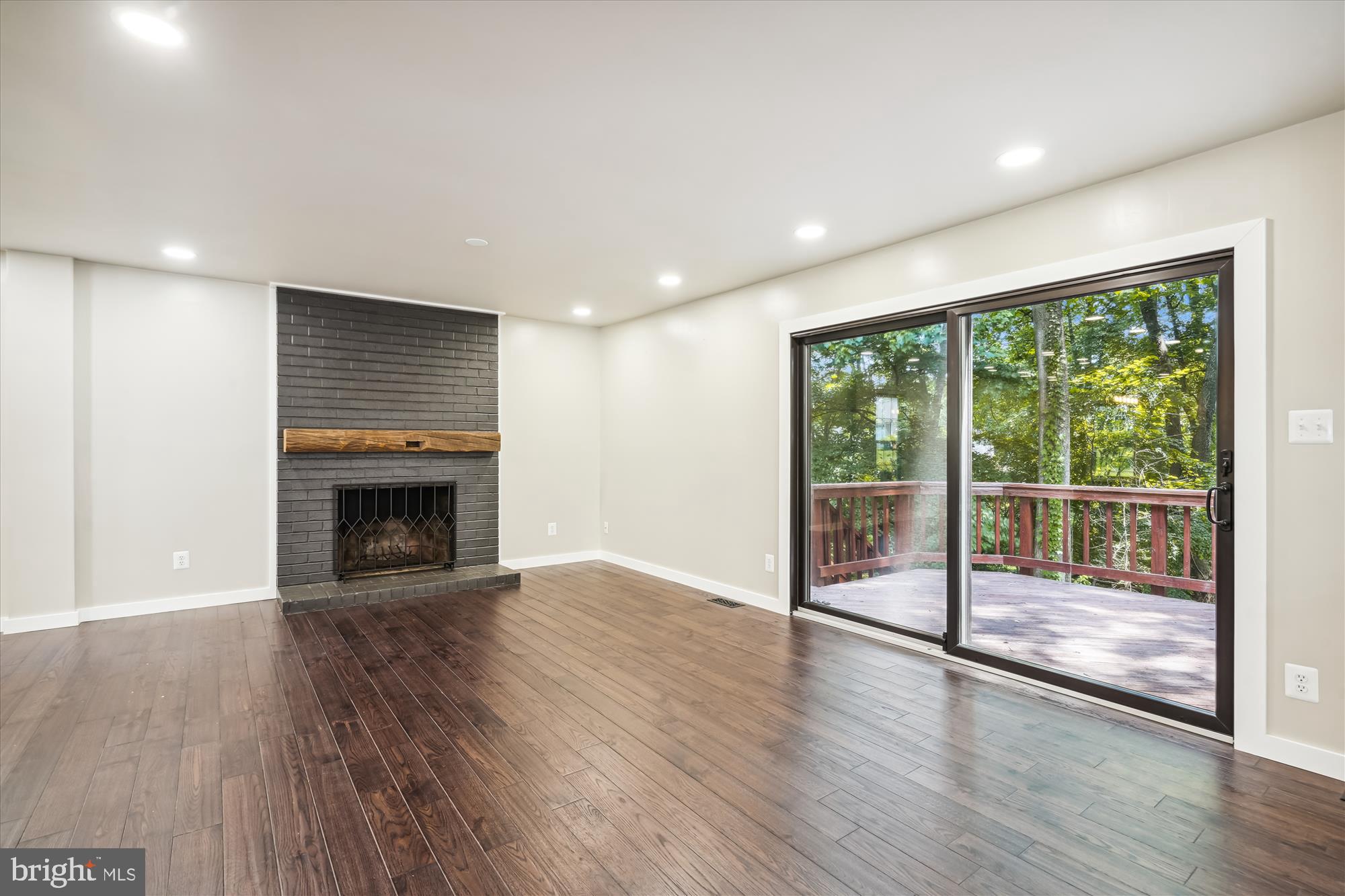 2613 Mountain Laurel Place Reston, VA 20191 - Photo 3 of 78 a view of an empty room with wooden floor and a fireplace