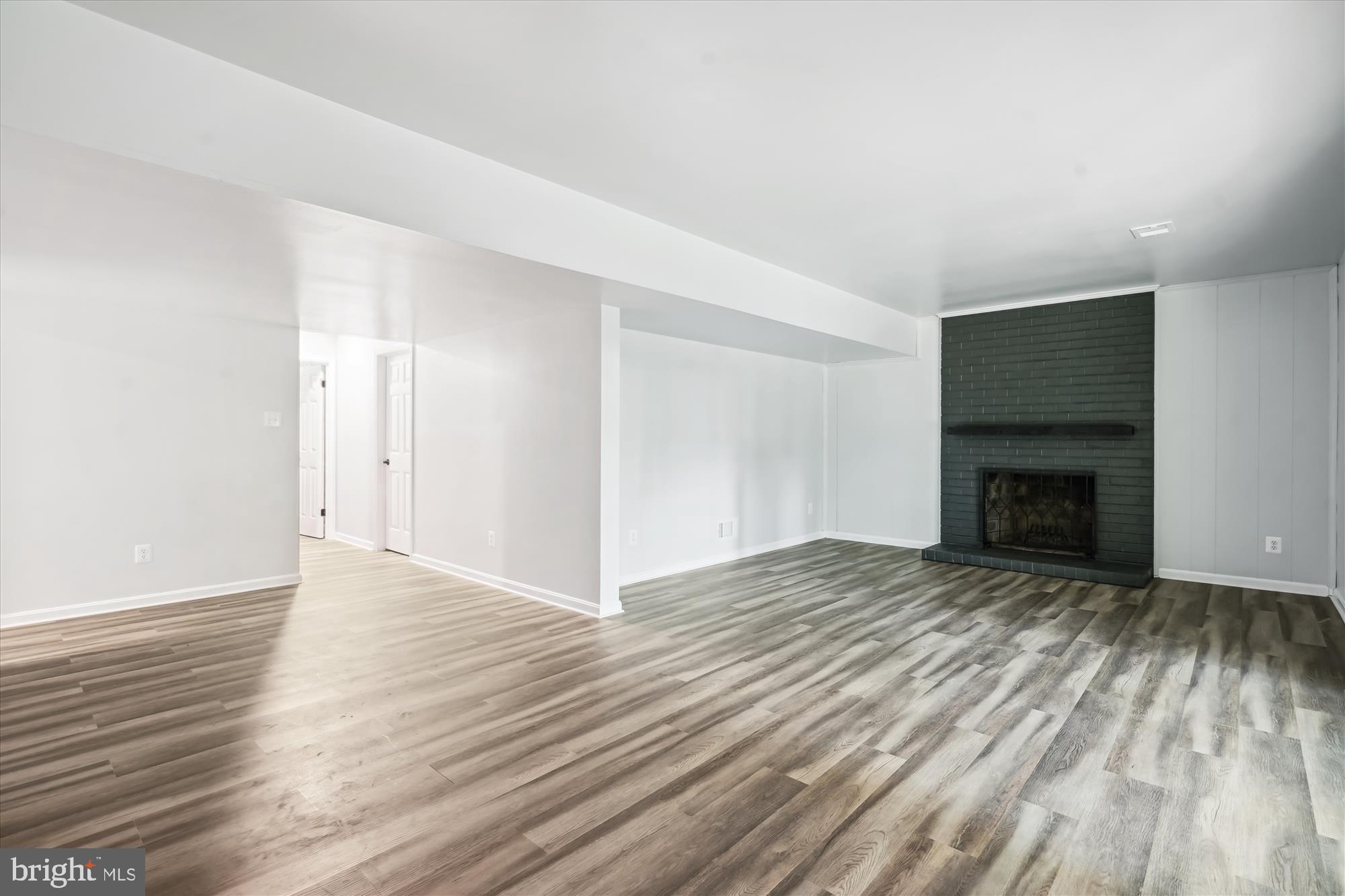 2613 Mountain Laurel Place Reston, VA 20191 - Photo 34 of 78 a view of an empty room with wooden floor fireplace and a window
